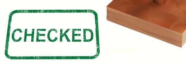 A wooden stamp with the word checked written on it.